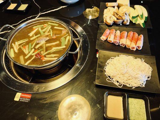 Beef broth hotpot special (dinner) with all its sides and sauce.  That vegetable plate is $25 on the plate that is size of a palm.