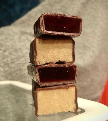 Cross sections of chocolate covered halvah and chocolate covered jellee.