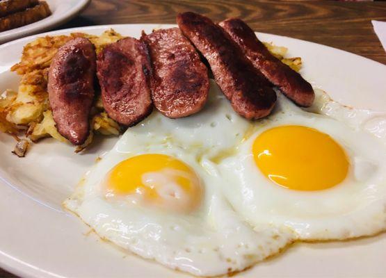 Beef sausage, two sunny side up eggs, home fries, toast