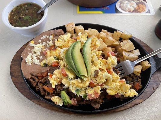 Mexican Steak, Mexican style eggs, refried beans. and home fries.