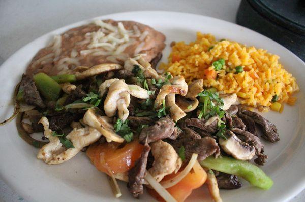 A delicious plate of fajitas served with rice and beans!