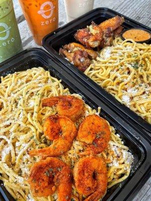 Garlic Noodles & Fried Shrimps/Chicken Wings features wheat noodles tossed in of parsley, garlic, cotij cheese, butter, and our spicy house.