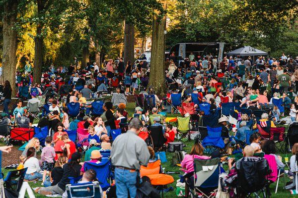 A crowd of visitors enjoy a concert at a Summer Friday at The Frick