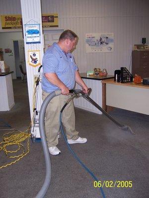 Brian cleaning the carpet at an office