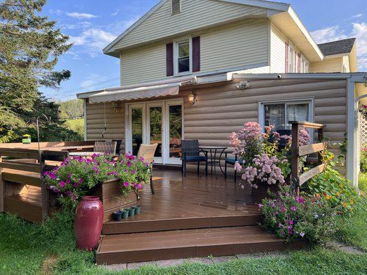 Back deck, clean decorated with flowers, place to seat and eat dinner, or read