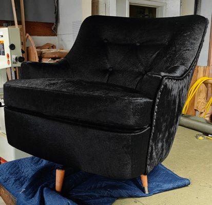 Black Hair On Hide, 70s style swivel rocking chair. Finished with decorative nails. New natural stain legs.