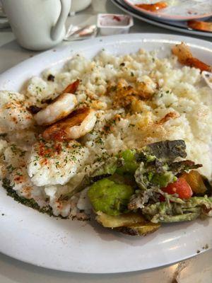 Lumpy grits and brown avocado