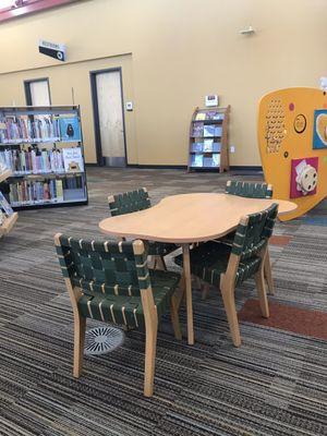 Interesting shaped table with sturdy chairs.