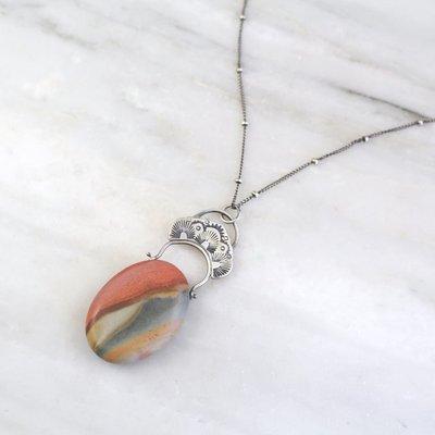 Polychrome jasper in a stamped silver setting.