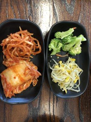 Side dishes - kimchi, radish salad, broccoli, and bean sprouts