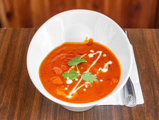 Chicken tikka masala is a dish consisting of roasted marinated chicken chunks in spiced gravy. The gravy is usually creamy and orange-colour