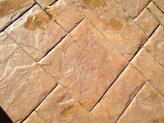 Stamped concrete patio resurfacing showing "effervescence" leaching.