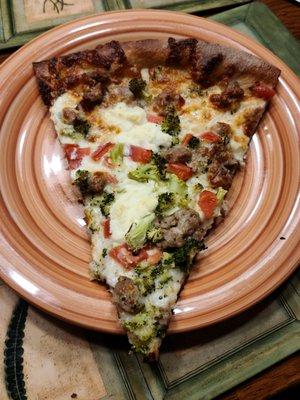 8 cut white pizza with broccoli, ricotta, tomato, and sausage