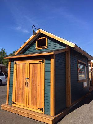 New siding and cedar wood trim and custom wood storage shed doors.