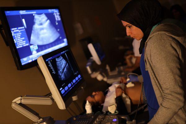 Diagnostic Medical Sonography student performing an ultrasound.