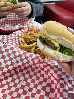 Sassy burger with a shared order of onion rings.