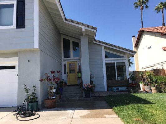 Exterior with yellow front door. They did a beautiful job! Clean, timely, professional. Would highly recommend.