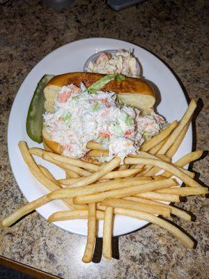 Crab sandwich with pickle, Cole slaw, and a side of fries