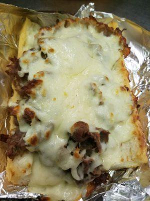 Italian Beef sandwich topped with Mozzarella cheese