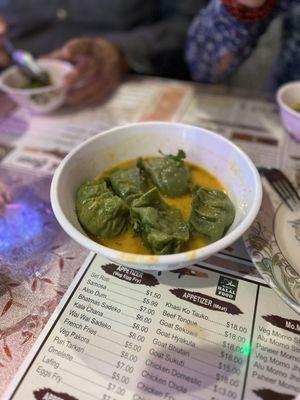 Goat Momos in a curry broth