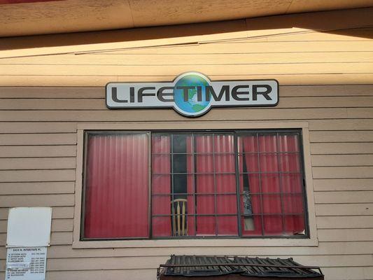 Our logo and window inside our humble "American-grit" style warehouse where we craft the world's leading therapy treatment tables.