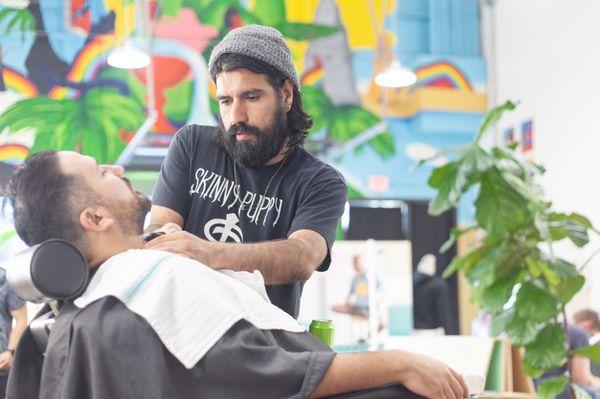 Michael giving chef Fermin Nunez (Suerte) a beard trim.