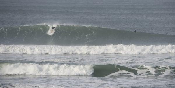 Aleks surfing if front of the shop. Picture by Darren Akana