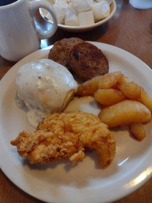 Biscuit with sausage gravy, sausage patties, baked apples & fried chicken tender