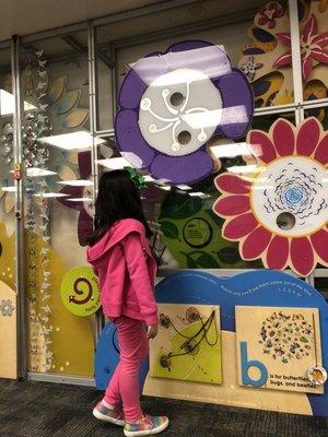 My daughter loves to play on their interactive wall. She manipulates wheels, magnets and measuring marker.