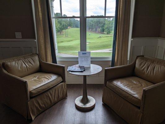 Inside the clubhouse. One of two seating areas overlooking the 18th hole near the bar.