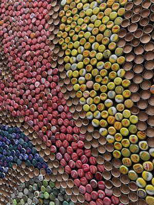 Close up of the bottle cap wall artwork next to the soda fountain