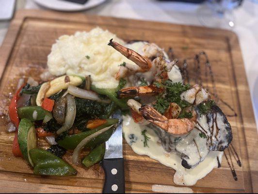 Surf (large shrimp) and Turf Ribeye with a Gorgonzola cheese sauce, grilled veggies, and creamy mashed potatoes.