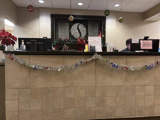 The front desk of the Spine and Scoliosis - Greensboro office is decorated with seasonal decor.