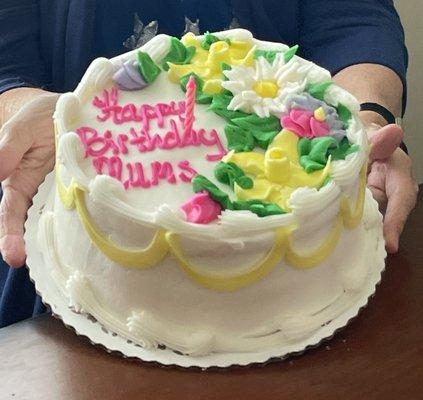 Round 2 tier white and buttercream. Spring flowers decor I think.