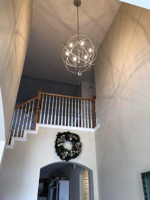 New orb style chandelier which is hung a few feet higher