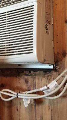 Rotten wood under dusty air conditioner