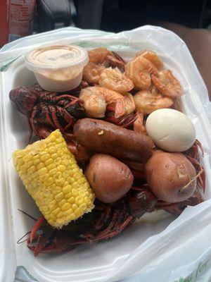 Crawfish, shrimp, corn, potatoes, sausage, egg with seafood dipping sauce