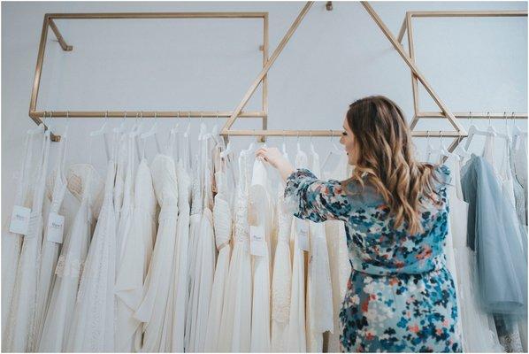 Boutique owner, Angelea, choosing gowns for a bridal appointment.