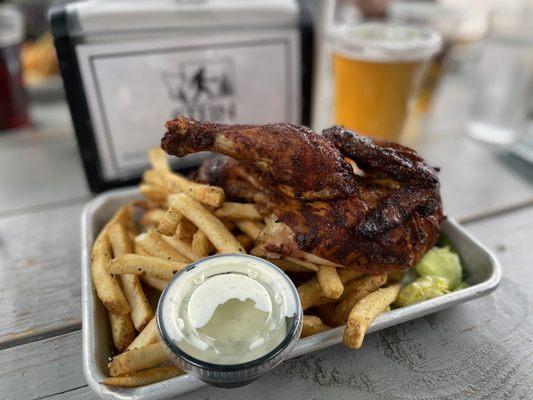 Half roast chicken meal with fries.