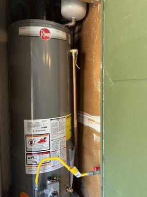 Tanked water heater installed in a broom closet of an Austin home.