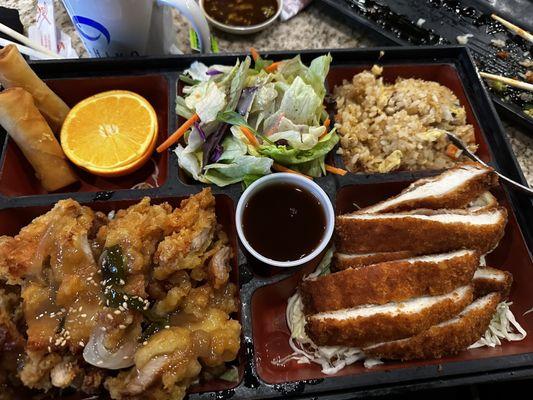 Select 2 bento with sesame chicken, chicken cutlet, fried rice, salad, and fried egg roll.