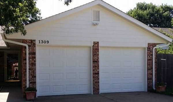 The newly installed HardiePlank siding and new rectangular gable vent.