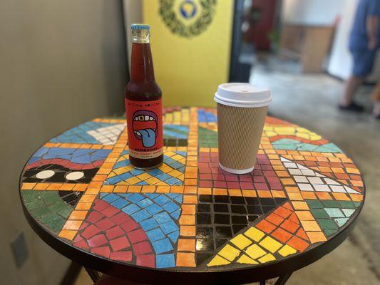 Dirty chai latte, locally made kombucha, on a mosaic style table