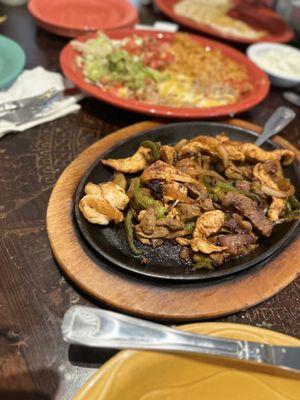 Trio Fajitas with rice, beans and extras.