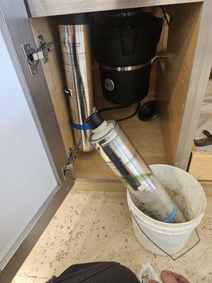 Changing plumbing filters under the sink