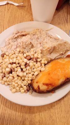 Chicken pot pie, baked potato, and corn with black eyed peas.