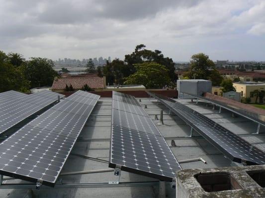 Solar panels tilted up on flat roof, so they aren't visible from the street.  Solar installation in Point Loma.