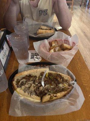 Philly Cheese Steak with peppers onions banana peppers and loaded cheese Fries