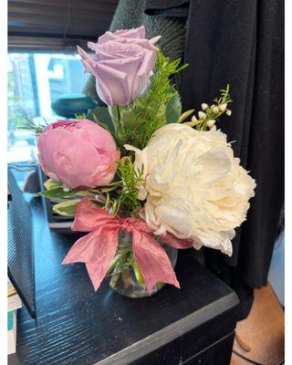 Peonies and roses for Mother's Day.  The arrangement includes a dark pink peony on the other side.