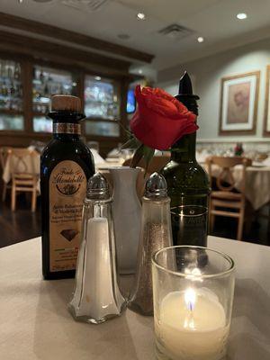 A beautiful red rose and candle adorns each table adding to the ambiance.